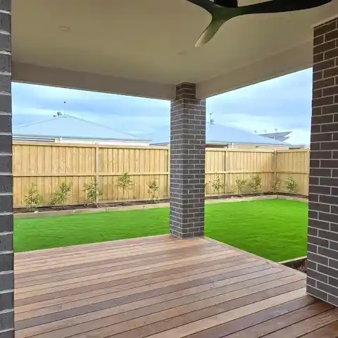 Finished hardwood deck under the verandah looking out to new lawn.